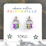 Tiny lgbtq toric pride chainmaille stud earrings on a white card. Each earring has a stainless steel ball with a steel link and 5 smaller links in the colors of the toric pride flag - violet, pink, light blue, light green and green